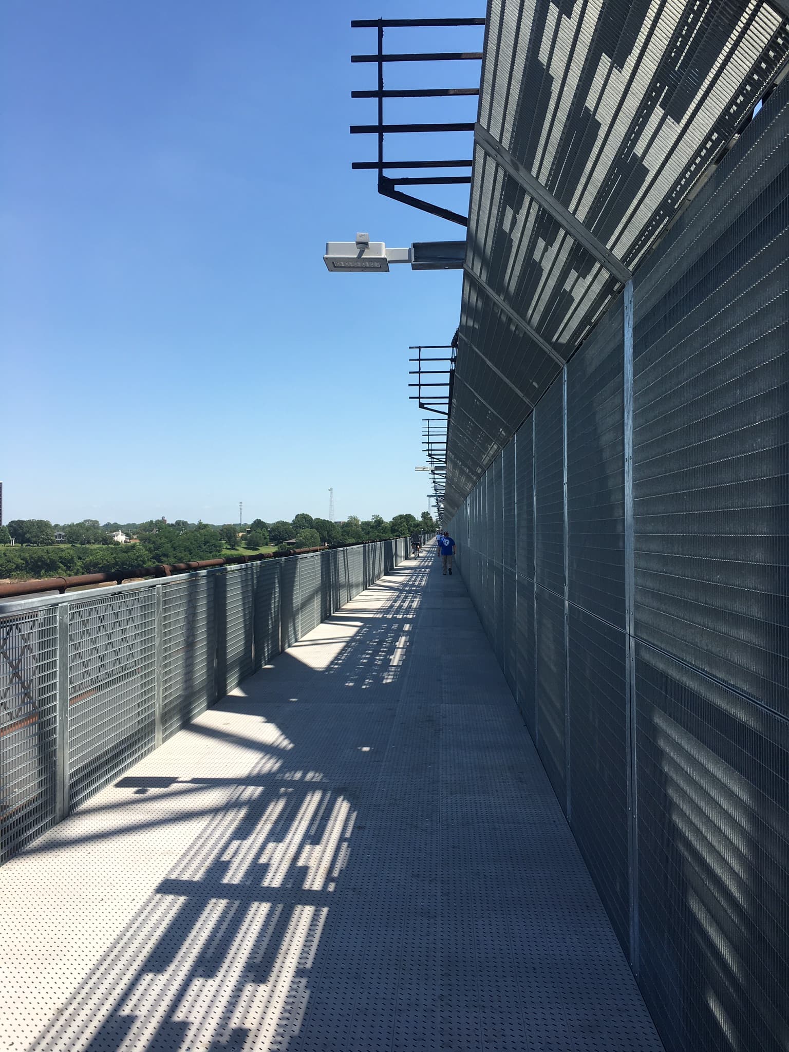The fenced pedestrian deck of the Big River Crossing on the Harahan Bridge over the Mississippi River