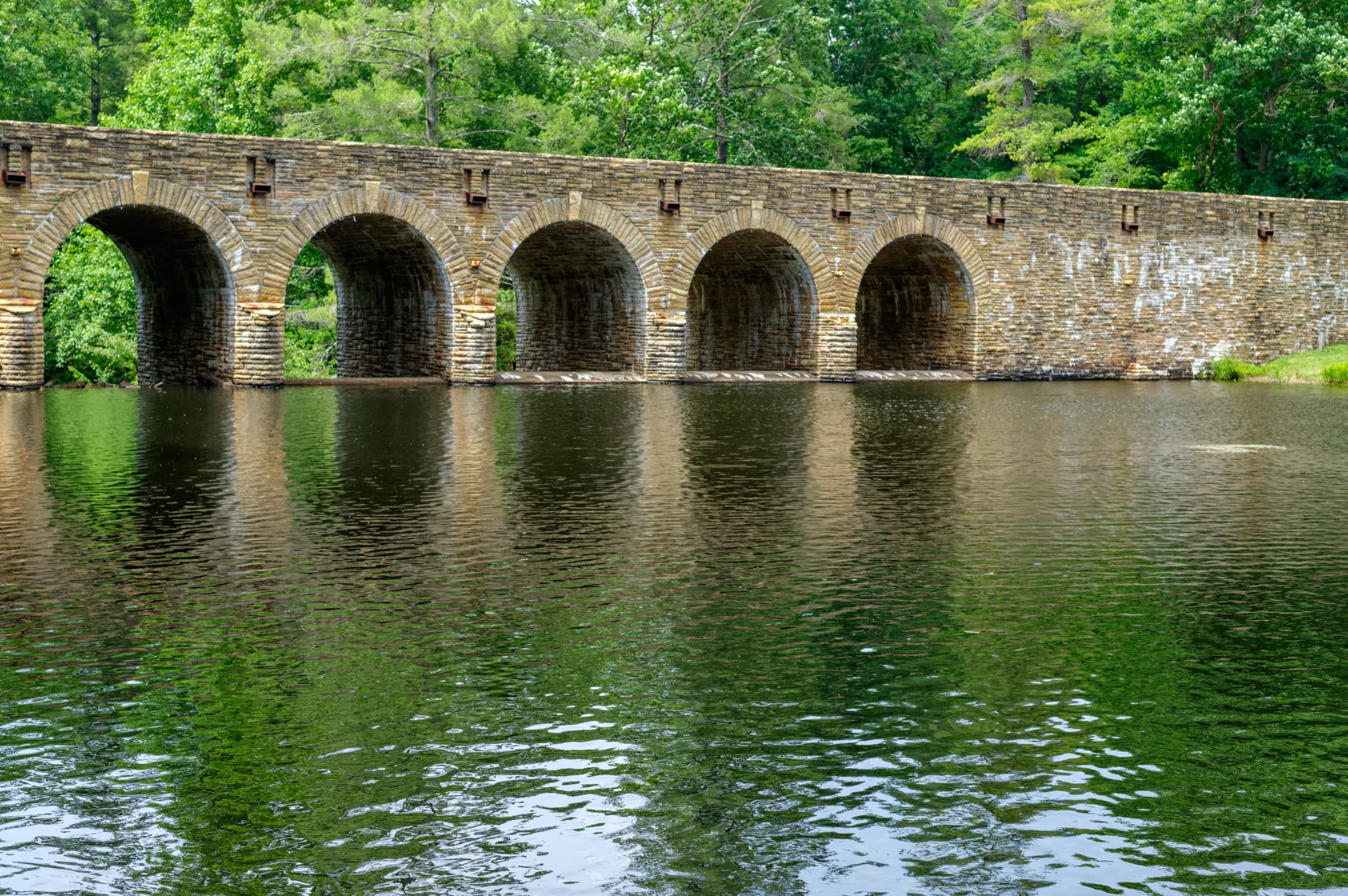 The CCC-built Crab Orchard stone arch dam and bridge over Byrd Lake at Cumberland Mountain State Park