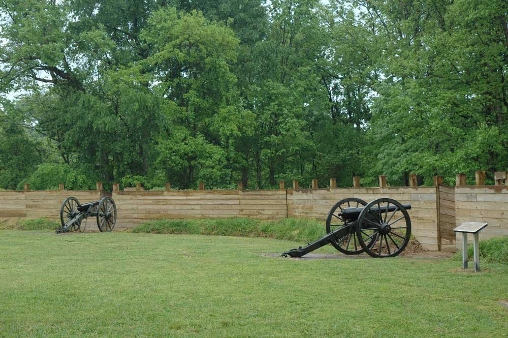Cannons behind the reconstructed wooden palisade of the restored fort at Fort Pillow