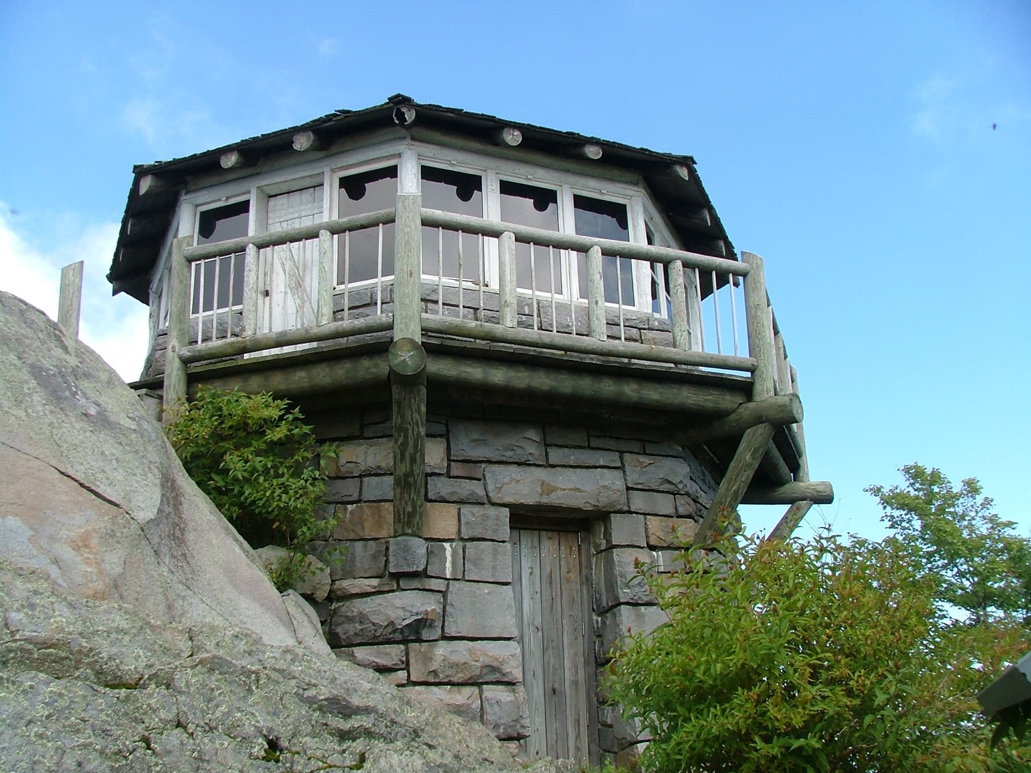 The restored stone-and-timber fire lookout standing on the rocky summit of Mount Cammerer